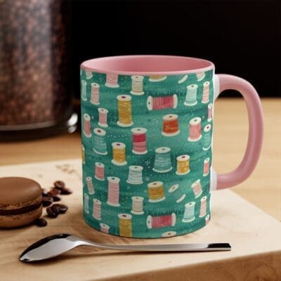 Adorable mug with colorful spools of thread and pink handle