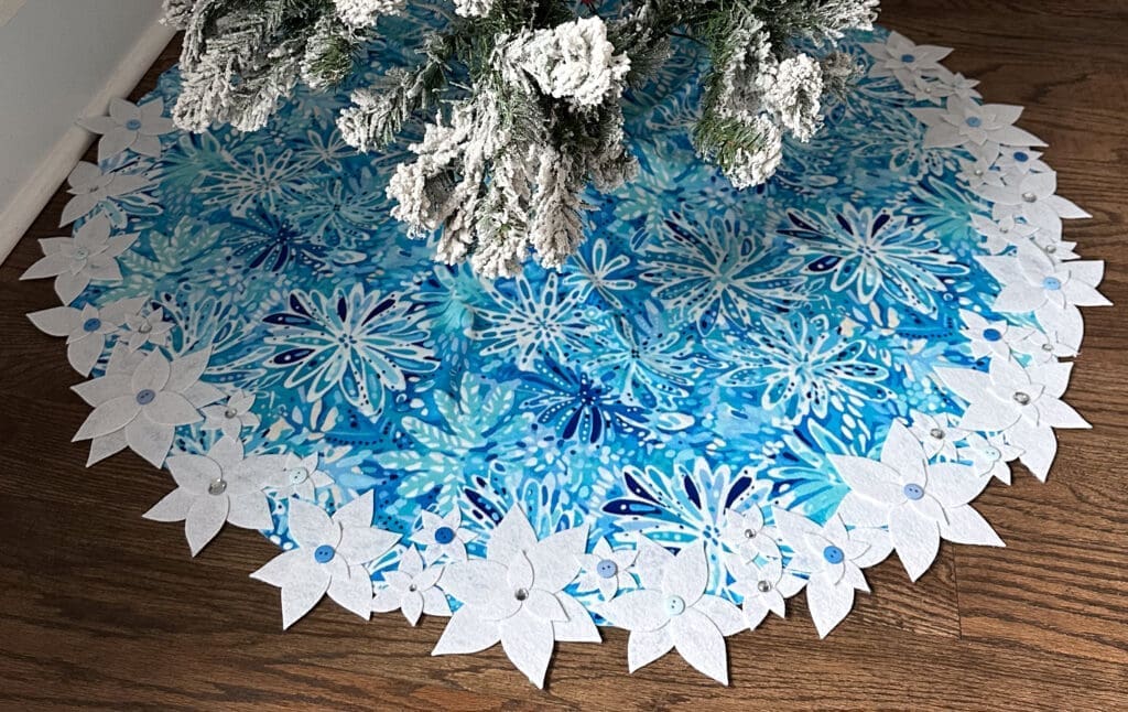 Minky DIY tree skirt in blue and white wintery print with white felt flower edge