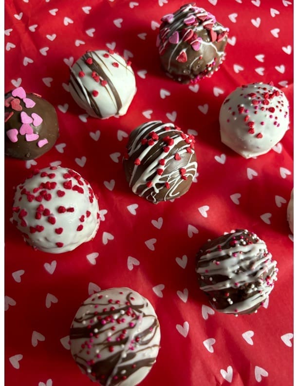 Valentine's Day cake pops on red heart fabric