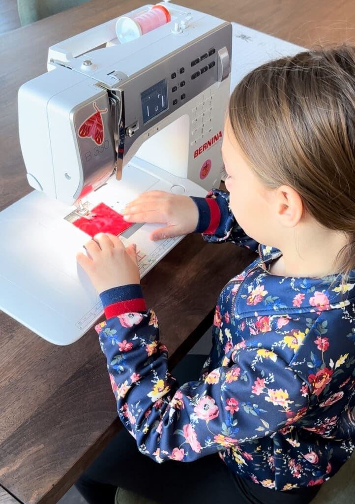 young girl sewing
