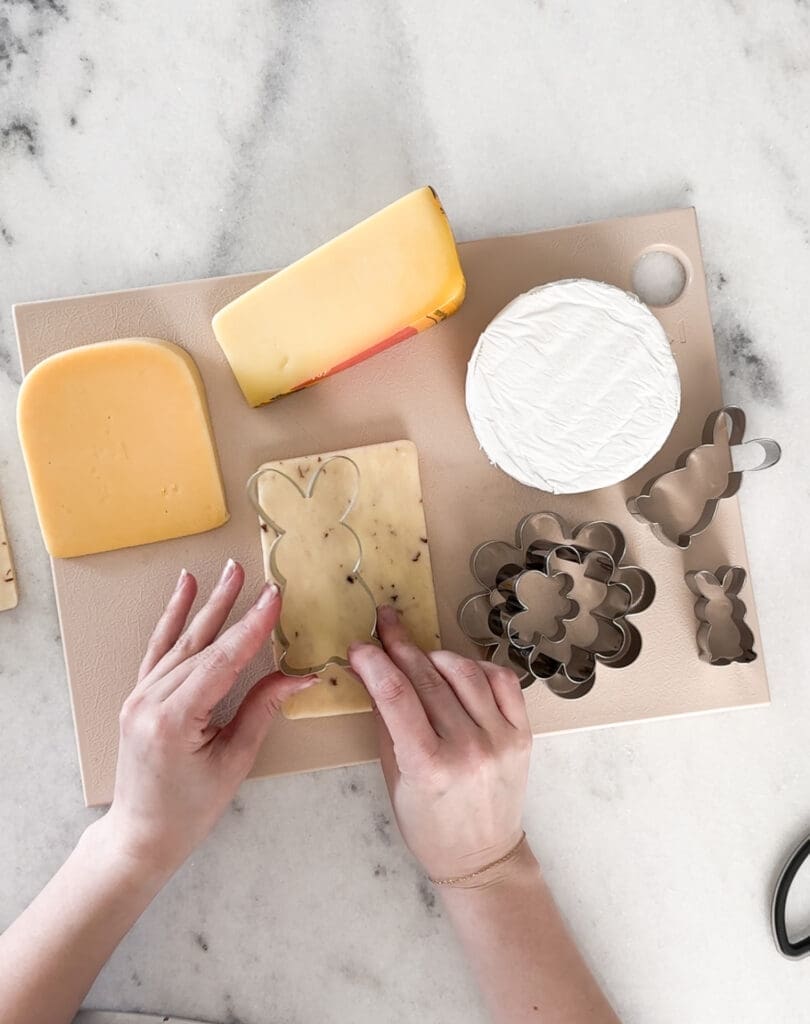 cutting bunny shaped cheese for easter charcuterie board